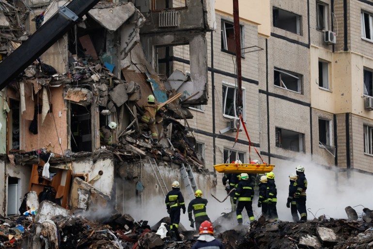 Emergency personnel work at the site where an apartment block was heavily damaged by a Russian missile raid in Dnipro, Ukraine.