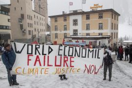 Climate activists display a banner during a protest ahead of the World Economic Forum (WEF) 2023 in the Alpine resort of Davos, Switzerland, January 15, 2023. REUTERS/Arnd Wiegmann