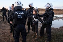 Police officers detain climate activist Greta Thunberg
