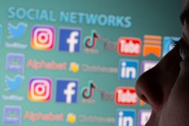 FILE PHOTO: Woman is seen in front of displayed social media logos in this illustration taken, May 25, 2021. Picture taken May 25, 2021. REUTERS/Dado Ruvic/Illustration/File Photo