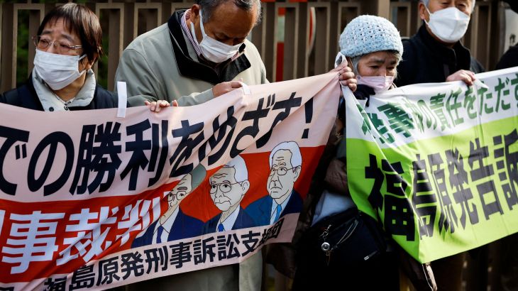 Supporters of plaintiffs hold banners after the the Tokyo High Court upheld a not guilty verdict for former Tokyo Electric Power Company executives over the 2011 Fukushima nuclear power station disaster, in Tokyo, Japan, on January 18, 2023