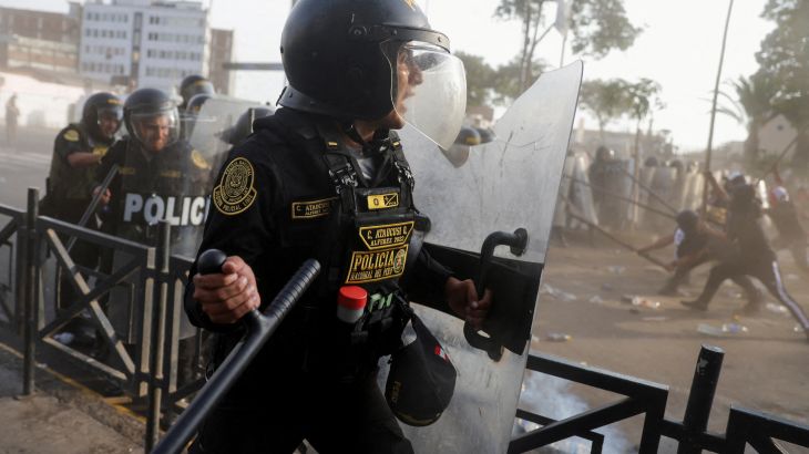 Protesters clash with riot police officers during the "Take over Lima" march to demonstrate against Peru's President Dina Boluarte