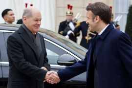 France's President Emmanuel Macron and German Chancellor Olaf Scholz arrive to attend a cabinet meeting as part of the celebration of the 60th anniversary of the signing of the Elysee Treaty in Paris, France January 22, 2023. Ludovic Marin /Pool via REUTERS