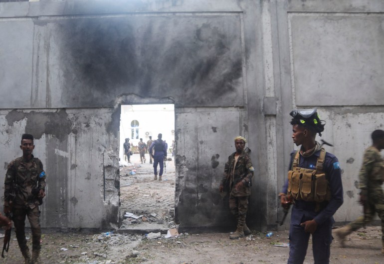 Somali security forces stand outside the mayor's office following a blast in Mogadishu