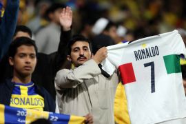 A fan of Saudi football club Al Nassr holds a Portugal shirt with Cristiano Ronaldo&#39;s name printed on the back [Ahmed Yosri/Reuters]