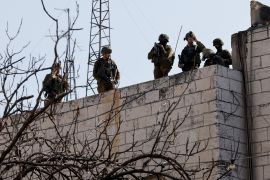 Israeli forces take up position during confrontations with Palestinians, in Hebron, in the Israeli-occupied West Bank