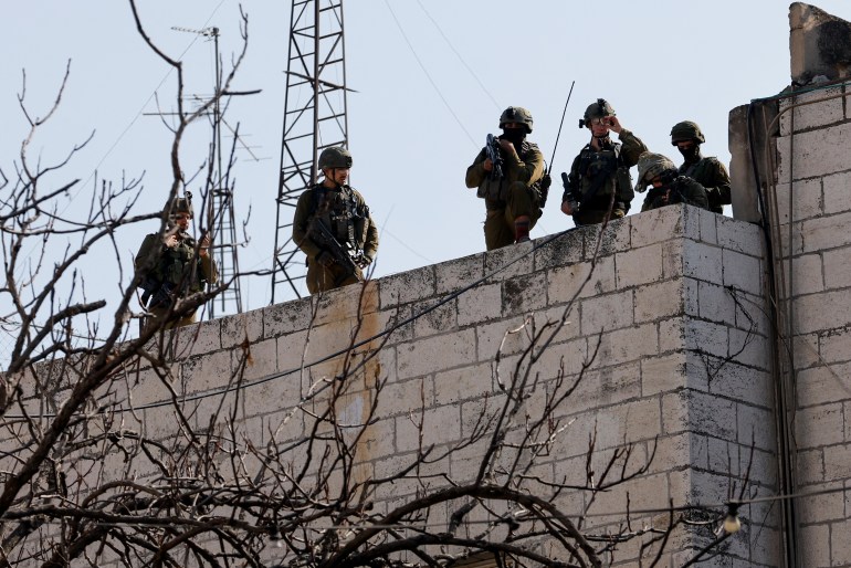 Israeli forces take up position during confrontations with Palestinians, in Hebron, in the Israeli-occupied West Bank.