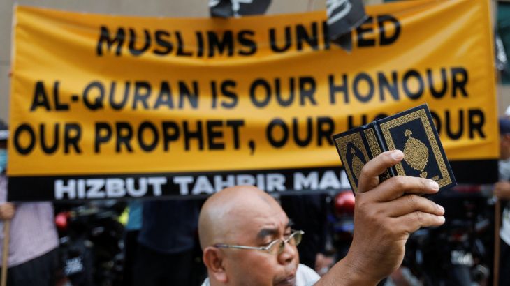 A man holds copy of the Koran during a protest in front of Swedish embassy after Rasmus Paludan, leader of Danish far-right political party Hard Line burned a copy of the Koran near the Turkish Embassy in Stockholm, in Kuala Lumpur, Malaysia January 27, 2023. REUTERS/Hasnoor Hussain