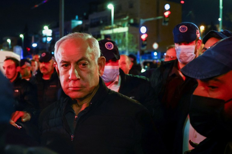 Israeli Prime Minister Benjamin Netanyahu visits the scene of a shooting attack.