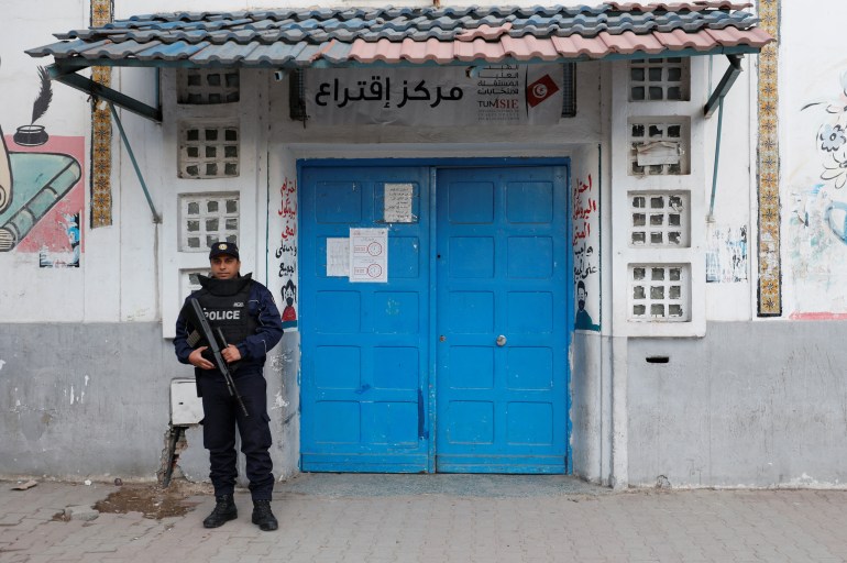 A police officer stands guard outside a polling station during the second round of the parliamentary election in Tunis, Tunisia January 29, 2023. REUTERS/Zoubeir Souissi