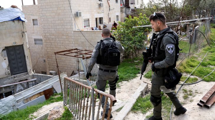 Israeli border police officers walk by the family home of Palestinian gunman Khaire Alkam as it is sealed off, after he killed people in a synagogue attack on the outskirts of Jerusalem, in A-Tur, East Jerusalem January 29, 2023. REUTERS/Ammar Awad