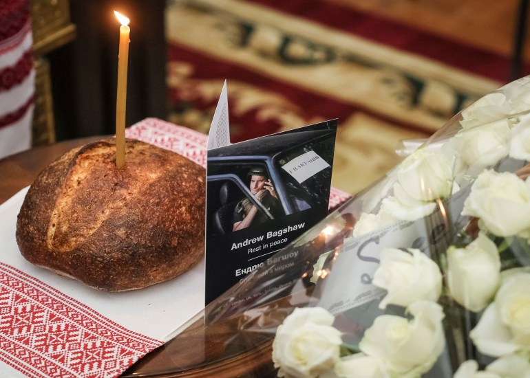 A booklet with a portrait of Andrew Bagshaw, one of the two British volunteers killed in eastern Ukraine while attempting a rescue from Soledar, amid Russia's attack on Ukraine, is seen during a memorial service in Kyiv, Ukraine January 29, 2023. REUTERS/Gleb Garanich NO RESALES. NO ARCHIVES