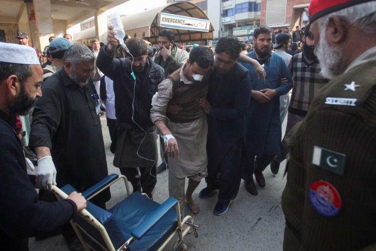 Men move an injured victim, after a suicide blast in a mosque, at hospital premises in Peshawar, Pakistan January 30, 2023
