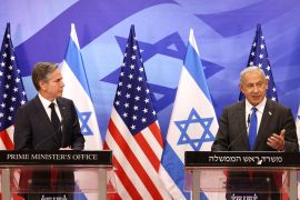 Blinken standing next to Netanyahu