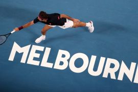 Switzerland's Roger Federer makes a backhand return to Australia's John Millman during their third round match at the Australian Open tennis championship in Melbourne, Australia