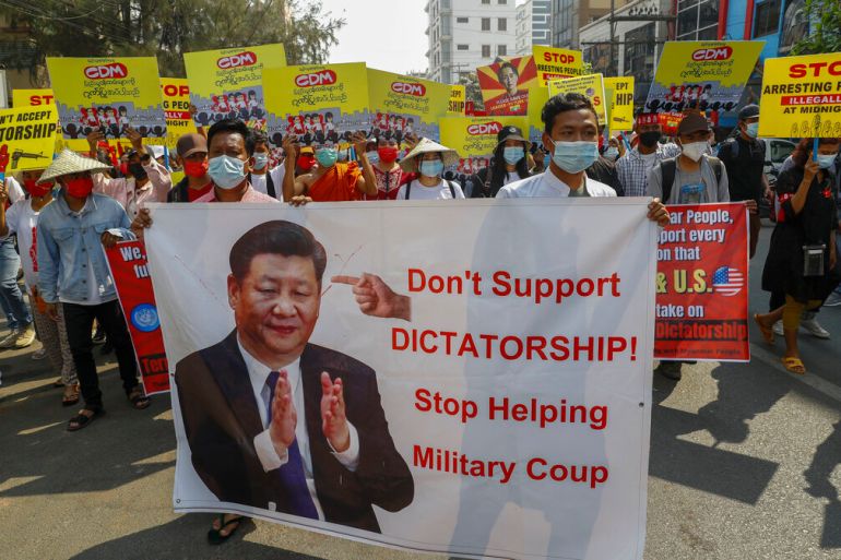 Demonstrators display a picture of Chinese president Xi Jinping, with a message requesting not to support military coup during a protest against the military coup in Mandalay, Myanmar