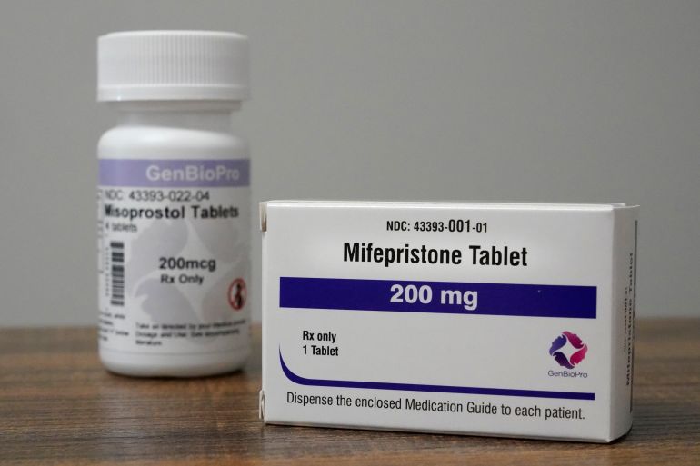 Containers of the medication used to end an early pregnancy sit on a table inside a Planned Parenthood clinic.