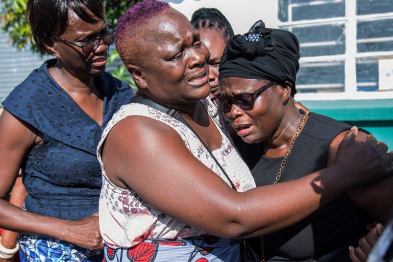 Florence Nyirenda, mother of Lemekhani Nyireda, is comforted by family members at the Kenneth Kaunda International Airport in Lusaka, Zambia, Sunday, Dec. 11 2022. The body of a 23-year-old Zambian student who died while fighting for the Russian army in the war in Ukraine has been returned home. The body of Lemekani Nyirenda who was studying nuclear engineering in Russia before joining the military arrived at Kenneth Kaunda International Airport in Lusaka on Sunday. (AP Photo/Salim Dawood)