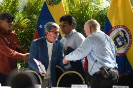 ELN's Pablo Beltran shakes hands with Otty Patino of the Colombian government