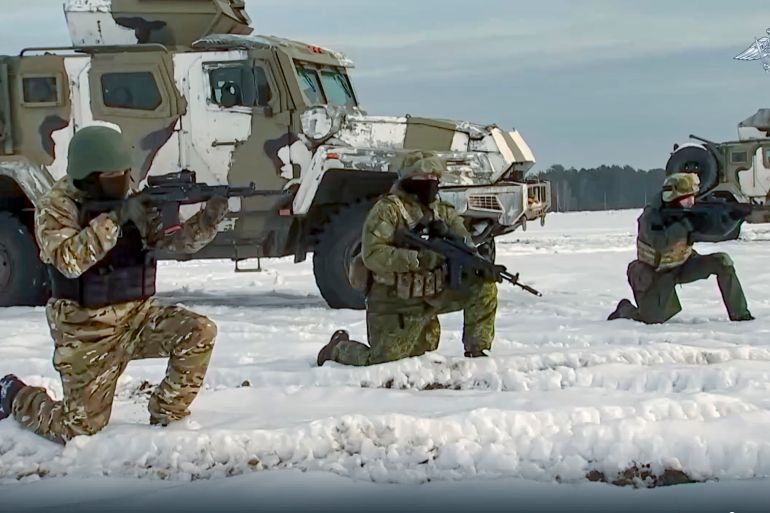 In this handout photo taken from video released by the Russian defence ministry on December 28, Russian troops take part in drills at an unspecified location in Belarus