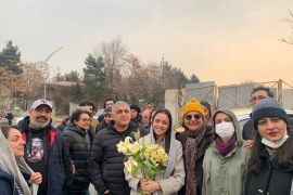 Iranian prominent actress Taraneh Alidoosti, center, holds bunches of flowers as she poses for a photo among her friends after being released from Evin prison in Tehran, Iran, Wednesday, Jan. 4, 2023. Iran released Alidoosti, a prominent actress from an Oscar-winning film, nearly three weeks after she was jailed for criticizing a crackdown on anti-government protests. (Gisoo Faghfouri, Sharghdaily, via AP)