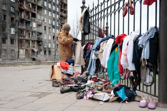 A local woman sells used clothes in Mariupol