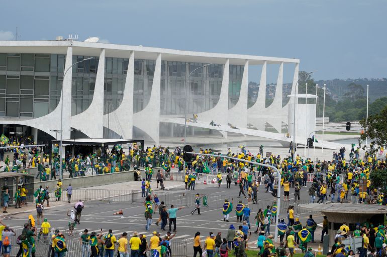A wide view of Brazil's presidential palace surrounded by rioters
