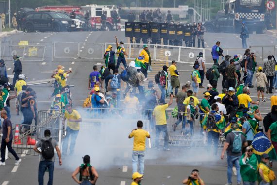 Protesters, supporters of former President Jair Bolsonaro, clash with police during a protest outside the Planalto Palace building in Brasilia, Brazil, Sunday, Jan. 8, 2023. Other demonstrators stormed congress and the Supreme Court.