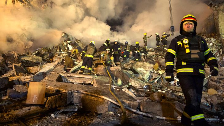 Emergency workers clear the rubble after a Russian rocket hit a multistory building in Dnipro