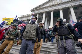 Members of the Oath Keepers extremist group stand on the East Front of the U.S. Capitol on Jan. 6, 2021