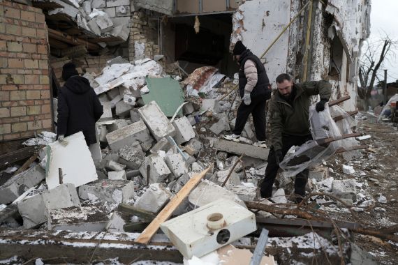 People check a destroyed house after a Russian rocket attack in Hlevakha, Kyiv