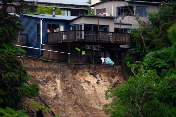 A landslip caused by flood water undermines a house in Auckland, Saturday, Jan. 28, 2023. Record levels of rainfall pounded New Zealand's largest city, causing widespread disruption.