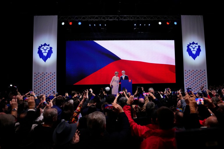 Czech Republic's President elect Petr Pavel with his wife Eva addresses his supporters after announcement of the preliminary results of the presidential runoff in Prague, Czech Republic, Saturday, Jan. 28, 2023. (AP Photo/Petr David Josek)