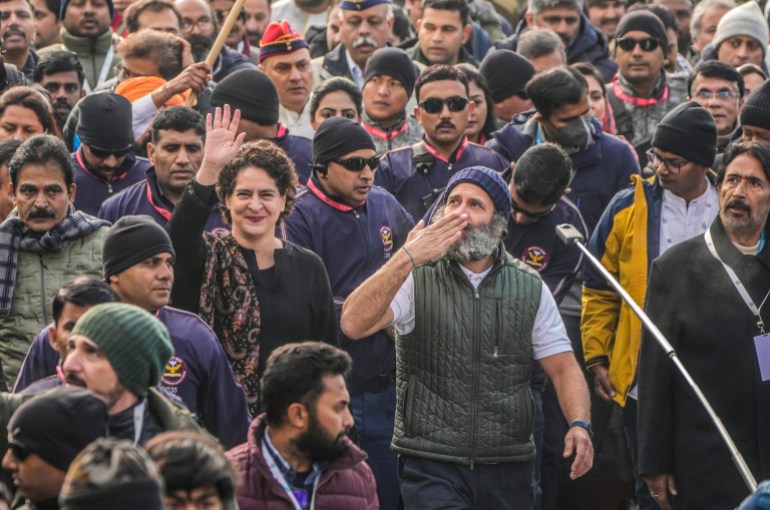 India's opposition Congress party leader Rahul Gandhi, center right and his sister and party leader Priyanka Vadra, center left, gesture toward the crowd as they walk with their supporters during a 5-month-long "Unite India March," in Srinagar,