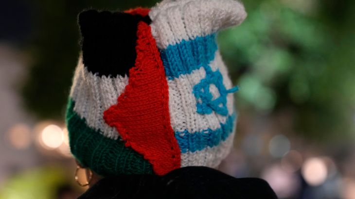 A person wears a knit cap in the colors of the Palestinian and Israeli flags in Tel Aviv, Israel, during a protest against Prime Minister Benjamin Netanyahu's far-right government, Saturday, Jan. 7, 2023.