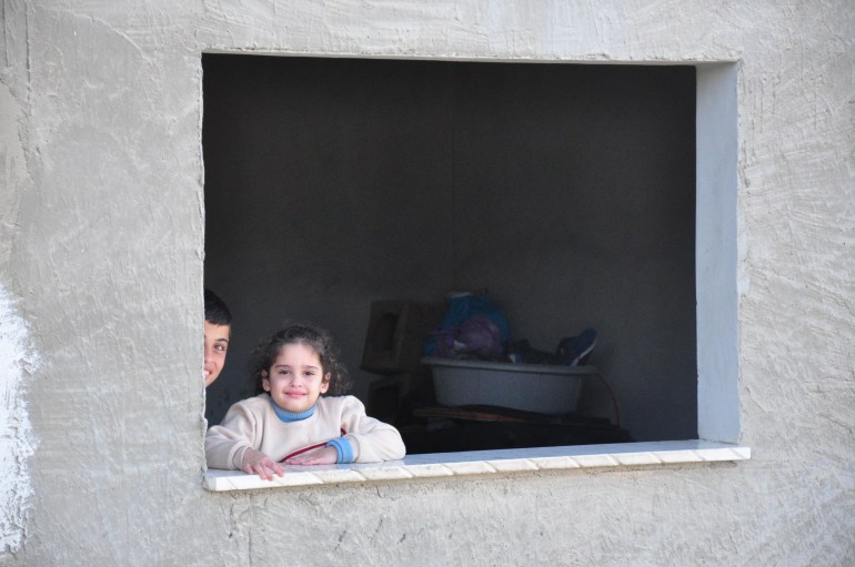 The children of Diana Qreini whose home was hit with bullets from several directions during the raid