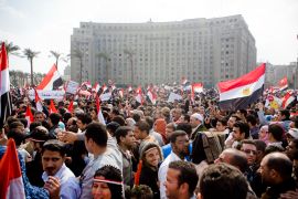 Protesters raise Egyptian flags in Tahrir Square