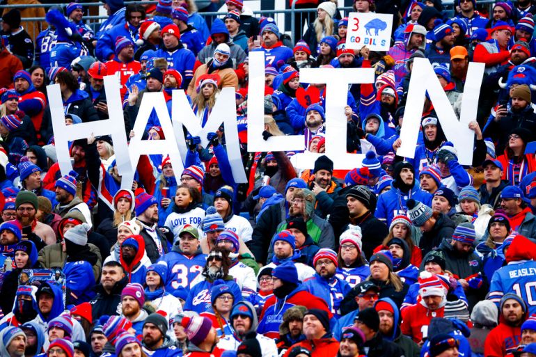 Buffalo football fans hold a sign spelling 'Hamlin' at a game.