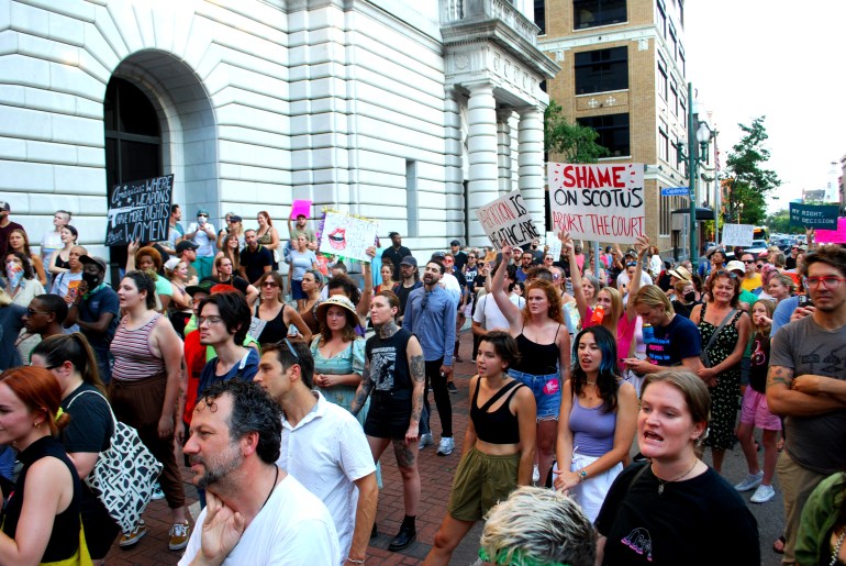 A photo of an abortion rights protest with a large group of people and posters.