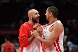 Tunisia's Radhouane Slimane and Mohamed Hadidane celebrate after a Basketball World Cup game against Angola