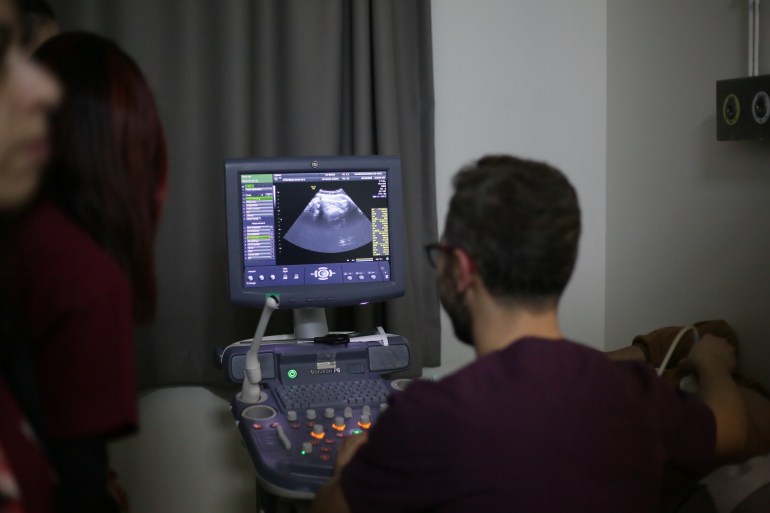A pregnant woman during a visit at the clinic [Ylenia/Gostoli/Al Jazeera]