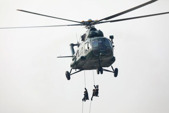 Soldiers repel down from a helicopter during a military parade to mark the 74th Armed Forces Day in the capital Naypyitaw
