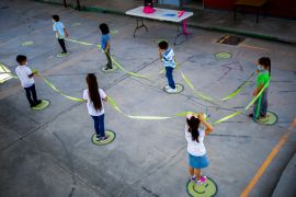 Children hold a cord to maintain social distance in a kindergarten, as in-person classes return after over a year of online lessons as the coronavirus disease (COVID-19) outbreak continues, in Ciudad Juarez, Mexico August 30, 2021. REUTERS/Jose Luis Gonzalez