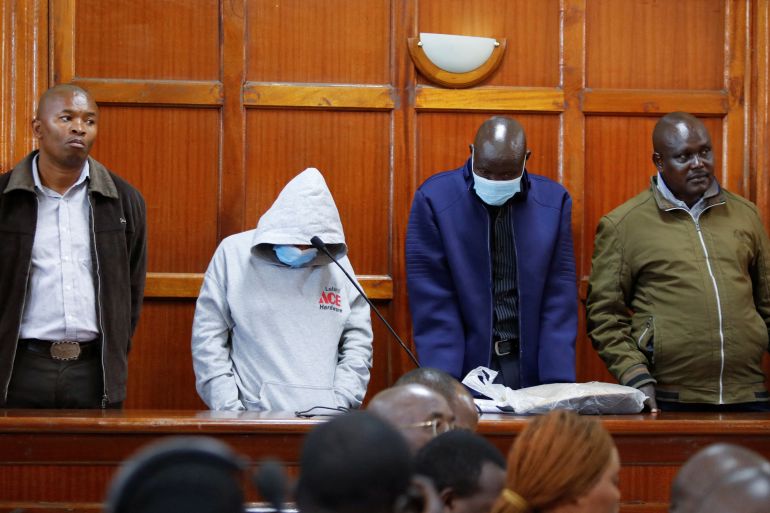Former Kenya police informer Peter Ngugi, former Kenya police officers Sylvia Wanjiku, Stephen Cheburet and Fredrick Ole Leilman stand in the dock