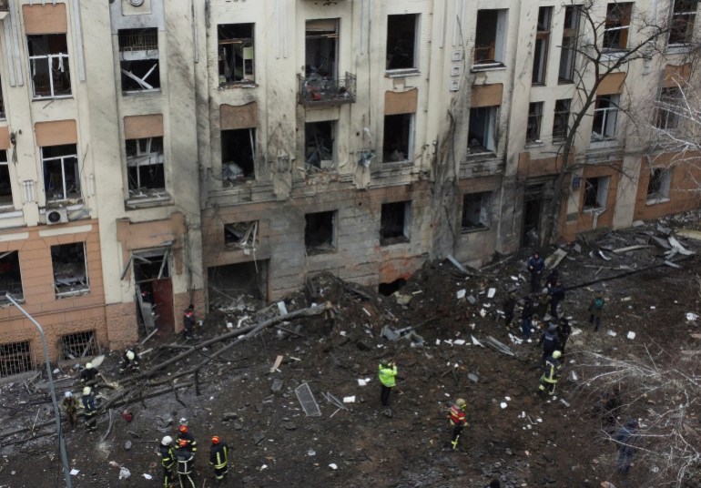 Rescuers work at the site of a residential building damaged by a Russian missile strike, amid Russia's attack on Ukraine, in central Kharkiv, Ukraine