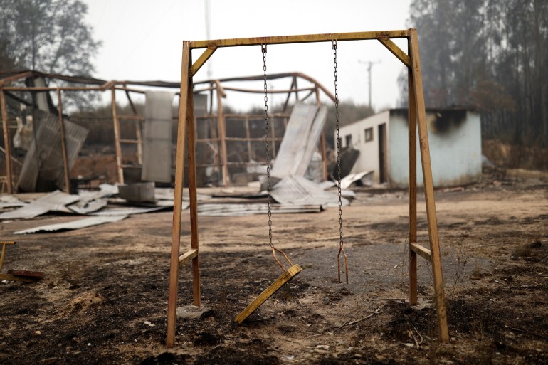 A swing in a destroyed area in Santa Juana, Chile, after a wildfire