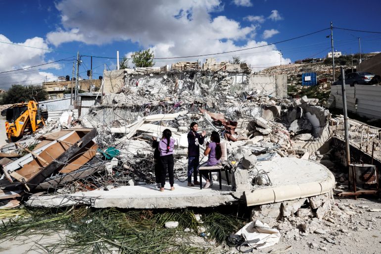 Palestinian children play on the remains of their home after it was demolished by Israeli forces