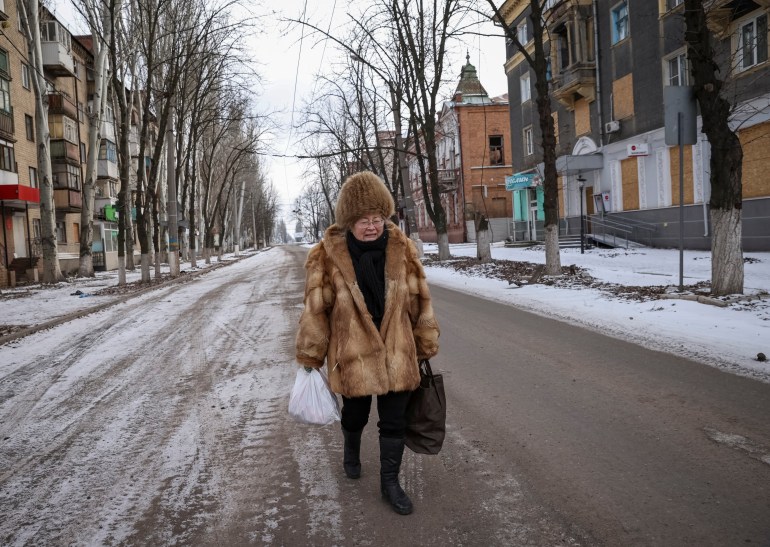 A local resident walks in an empty street in Bakhmut