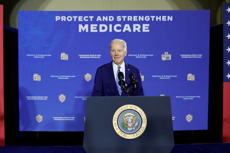 Biden stands at a podium before a banner that reads "Protect and strengthen Medicare"