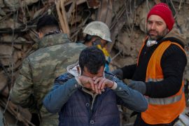 Brother of survivor Gokhan Ugurlu, 35, reacts as rescuers work in the aftermath of a deadly earthquake, in Hatay, Turkey February 12, 2023.